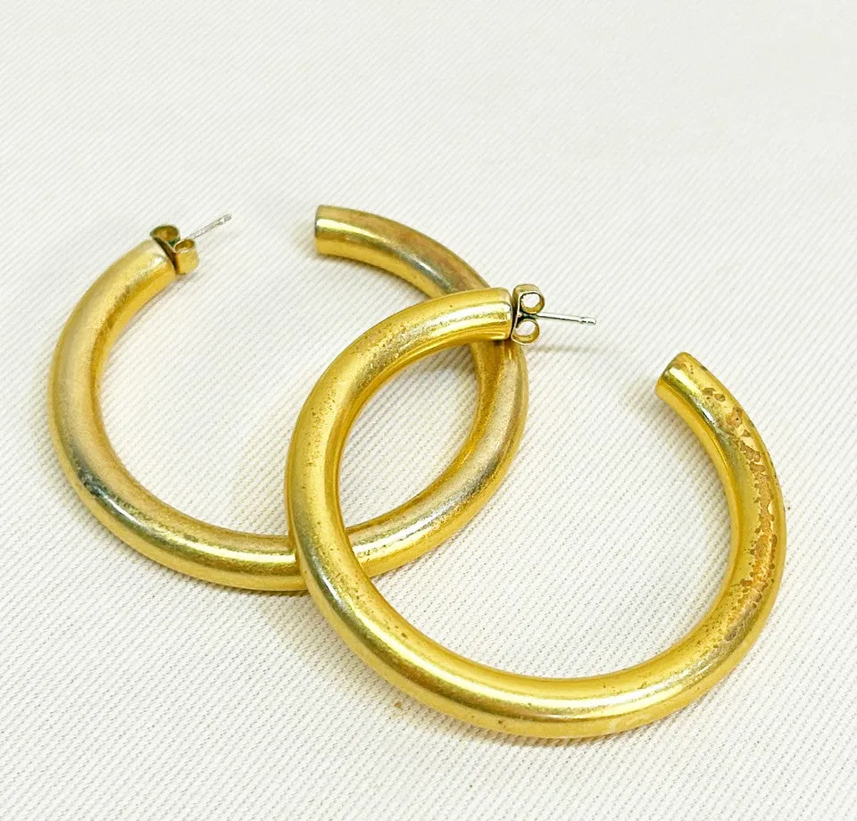 Extra large vintage gold metal tone hoop pierced earrings.